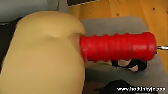 A huge dildo inserted into an anal opening