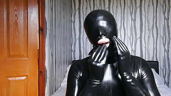 Latex-Clad Submissive Restrained And Silenced