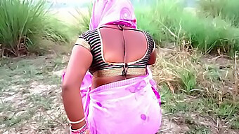 Indian mother-in-law kisses in the countryside during a visit to the farm